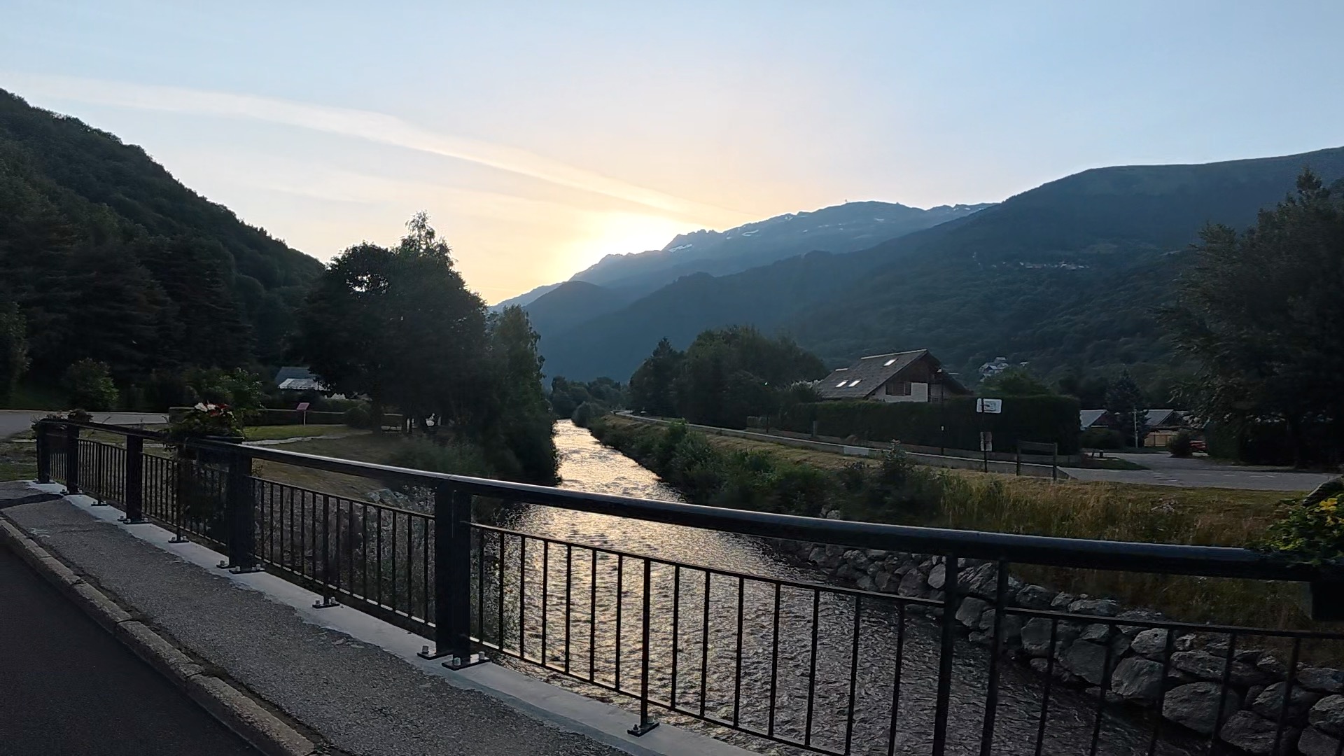 Long empty road out of Bourg d'Oisans with Alpes in distance. Horsham Cycling.